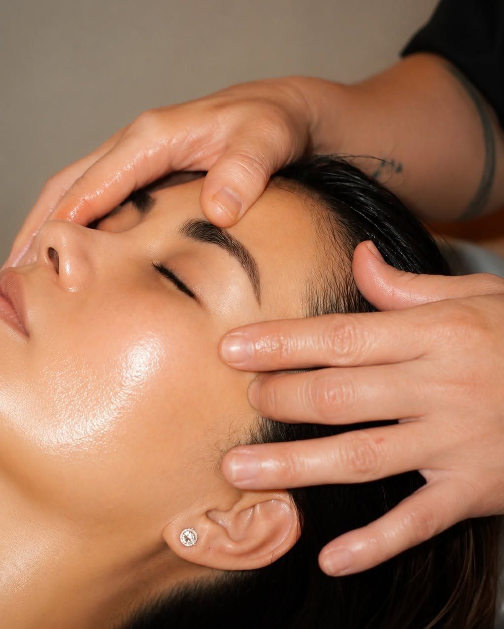 Therapist giving a relaxing head and temple massage