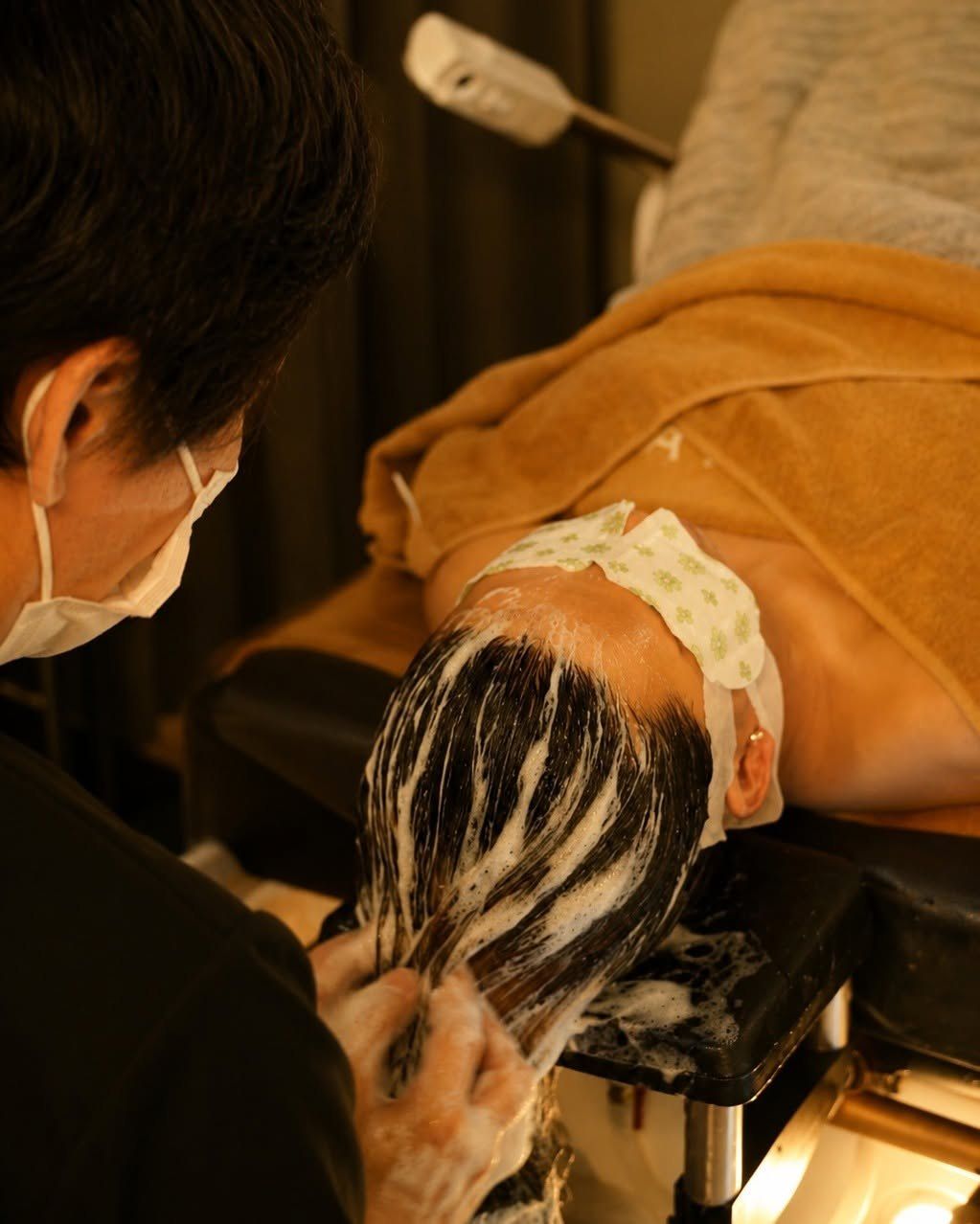 Gold Class therapist giving a tailored shampoo
